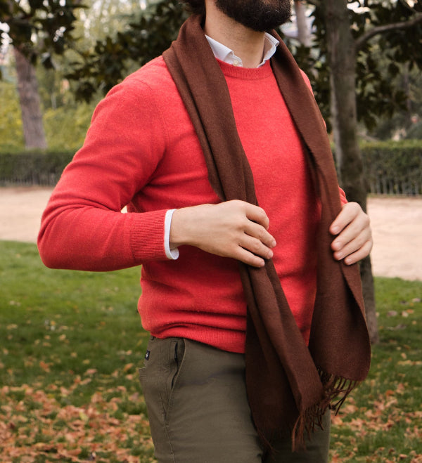 Modelo masculino en la natualeza conuna bufanda de baby alpaca de color chocolate